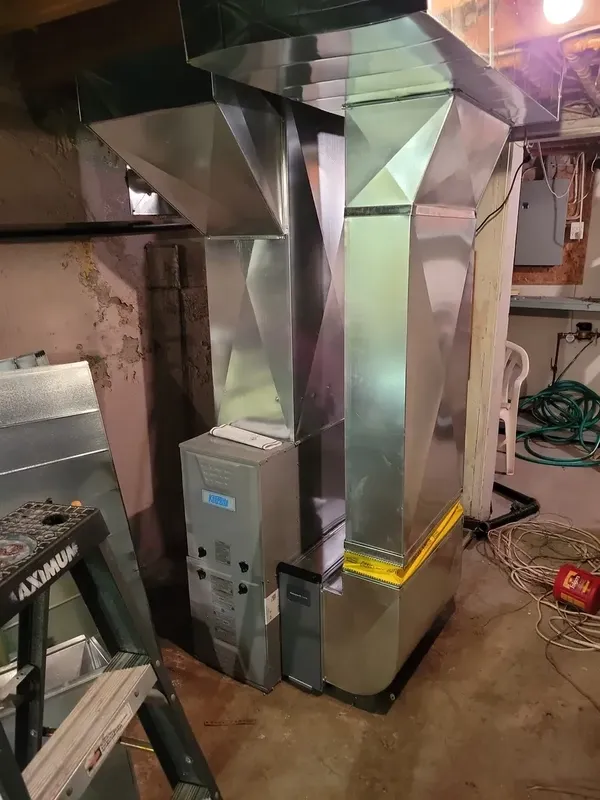 Technician inspecting rooftop unit filters and components