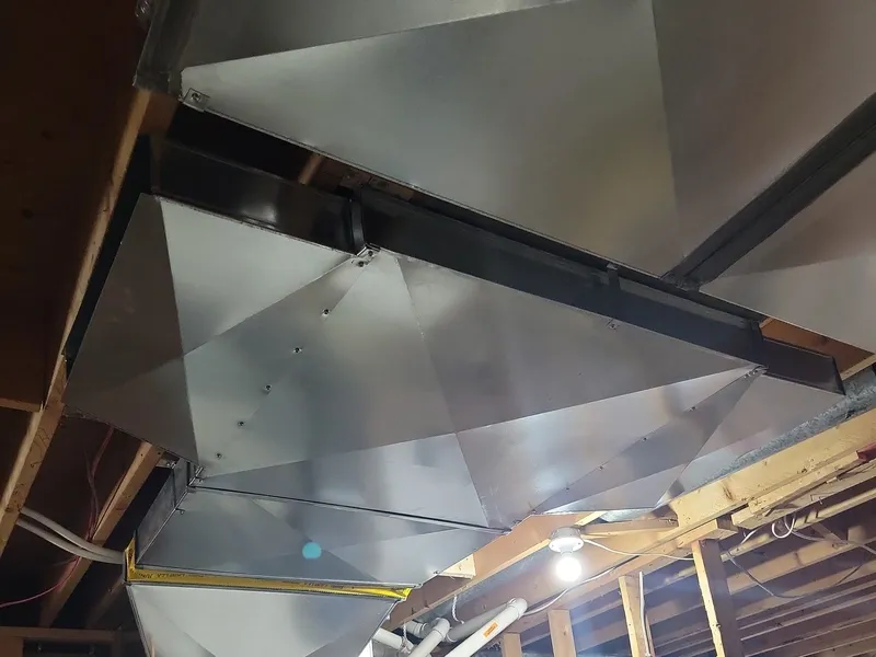 Galvanized steel trunk line installed in a Kitchener-Waterloo basement