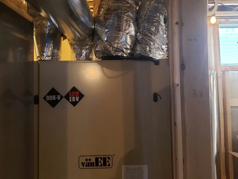 Heat recovery ventilator mounted on a basement wall in a Kitchener-Waterloo home