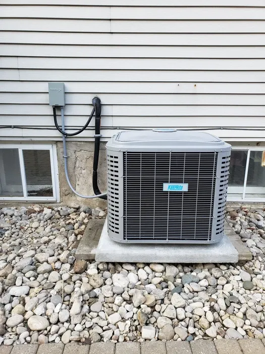Central air conditioning condenser unit on a concrete pad